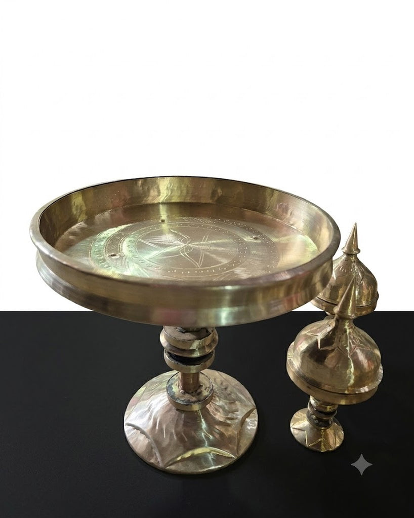 The open tray on its stem, close, a spired lid beside it; rings are turned round the rim and a star is cut into the tray floor.