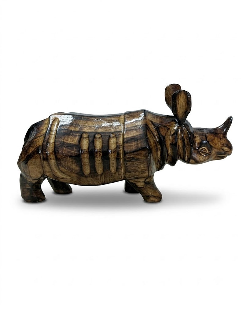The carved rhinoceros seen from the side on a white ground: dark and honey stripes along the body, the plated folds over shoulder and flank, and the single horn.