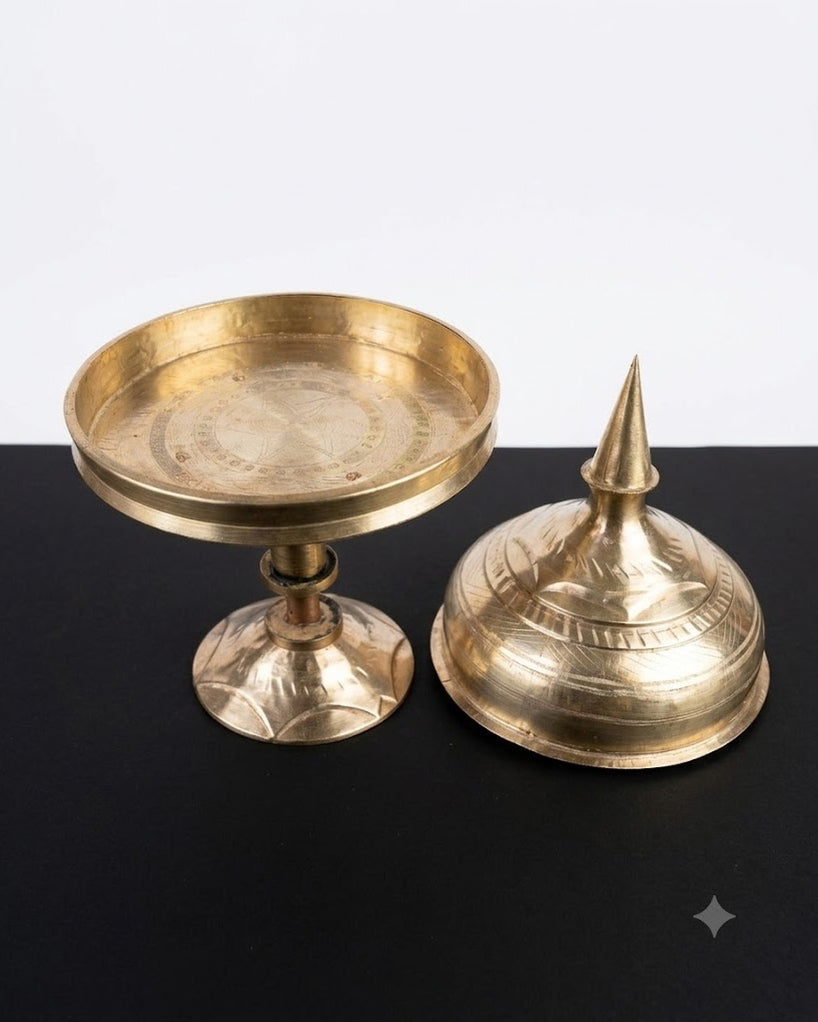 The tray and its lid side by side on a black surface: the open tray on its stem and foot, and the domed lid with its spire.