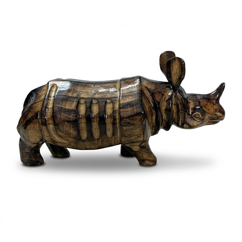 The carved rhinoceros seen from the side on a white ground: dark and honey stripes along the body, the plated folds over shoulder and flank, and the single horn.
