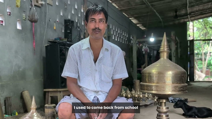 Haridas Das seated in his workshop beside a finished xorai, speaking about learning to make xorai after school from the age of ten, and the bell-metal craft of Sarthebari, with English subtitles a phrase at a time. 41 seconds.