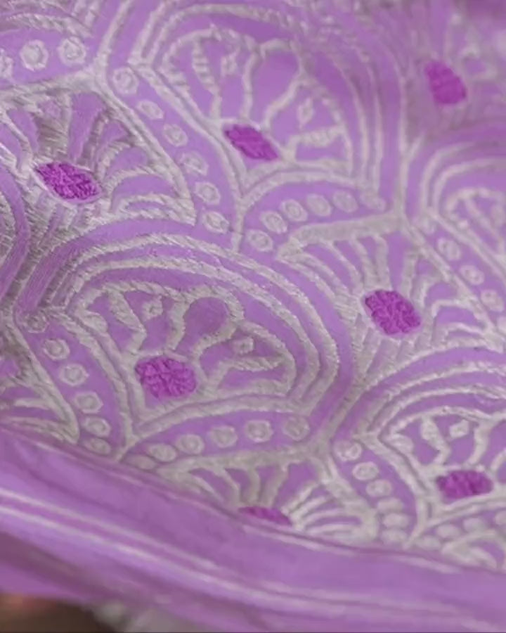 The pallu close and drifting: silver zari arches laid like fish scales, each centred on a violet square, on lavender.